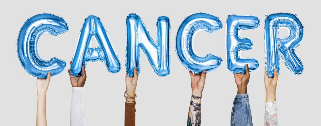 Hands showing cancer balloons word